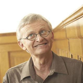 Man in front of wood panelled wall