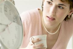 Worried woman looking at clock