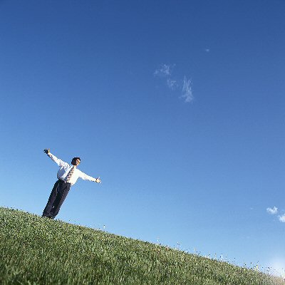 Man on Hill with Arms Raised
